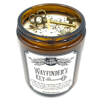 Wayfinder’s Key ritual candle with key, pyrite, wormwood, vervain and poppy seeds for doorway and crossroads magic by The Wild Cauldron.