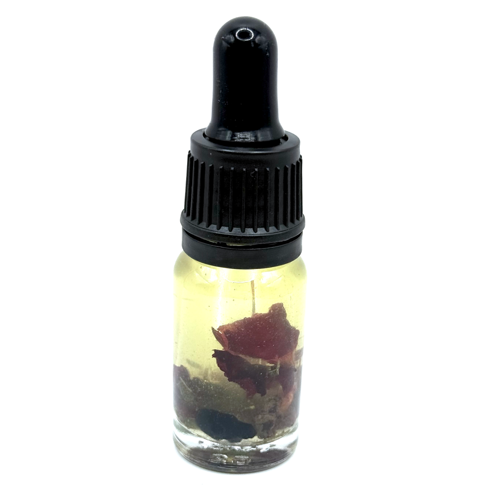 Persephone’s Oil – devotional underworld and renewal ritual oil with pomegranate, rose, cypress and garnet chips by The Wild Cauldron.