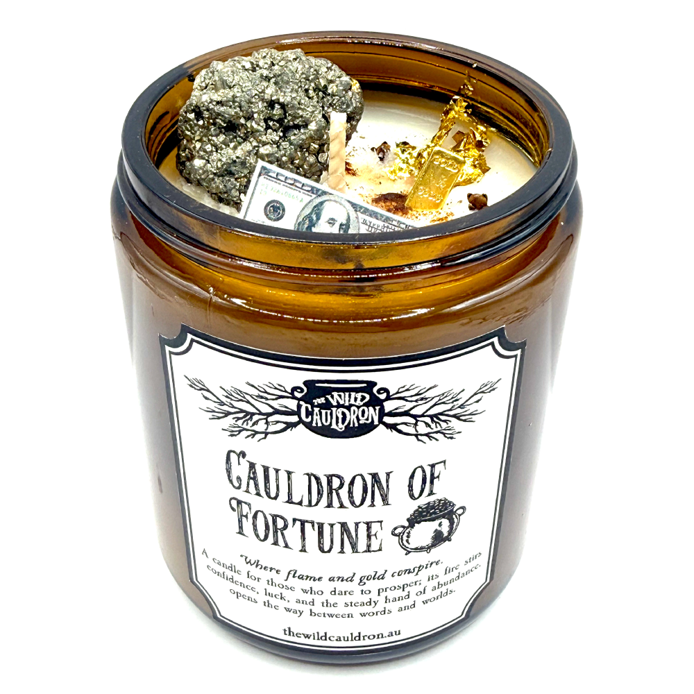 Cauldron of Fortune prosperity candle with pyrite, cinnamon, clove, gold leaf, gold brick charm and mini money note by The Wild Cauldron.