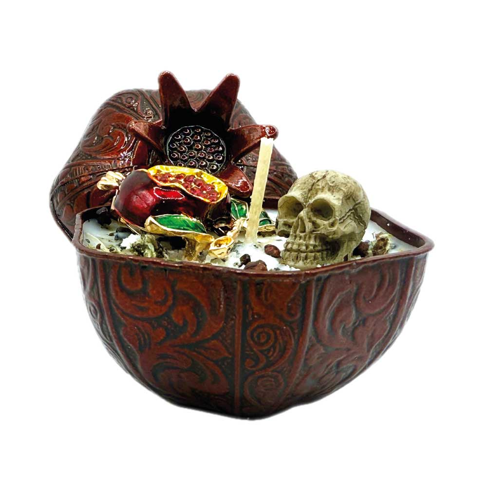 Persephone’s Flame candle with herbs, skull, brooch, and pomegranate charm