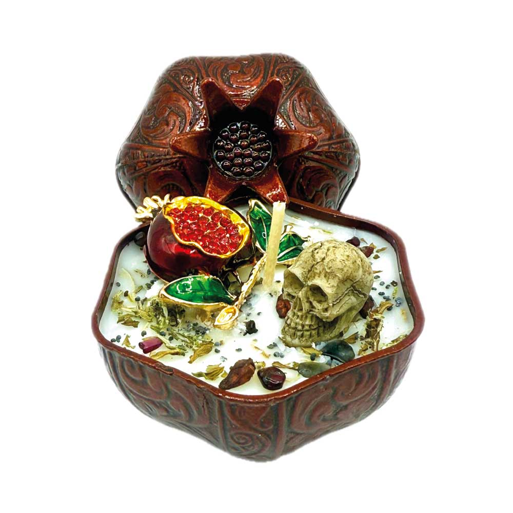 Persephone’s Flame candle with herbs, skull, brooch, and pomegranate charm