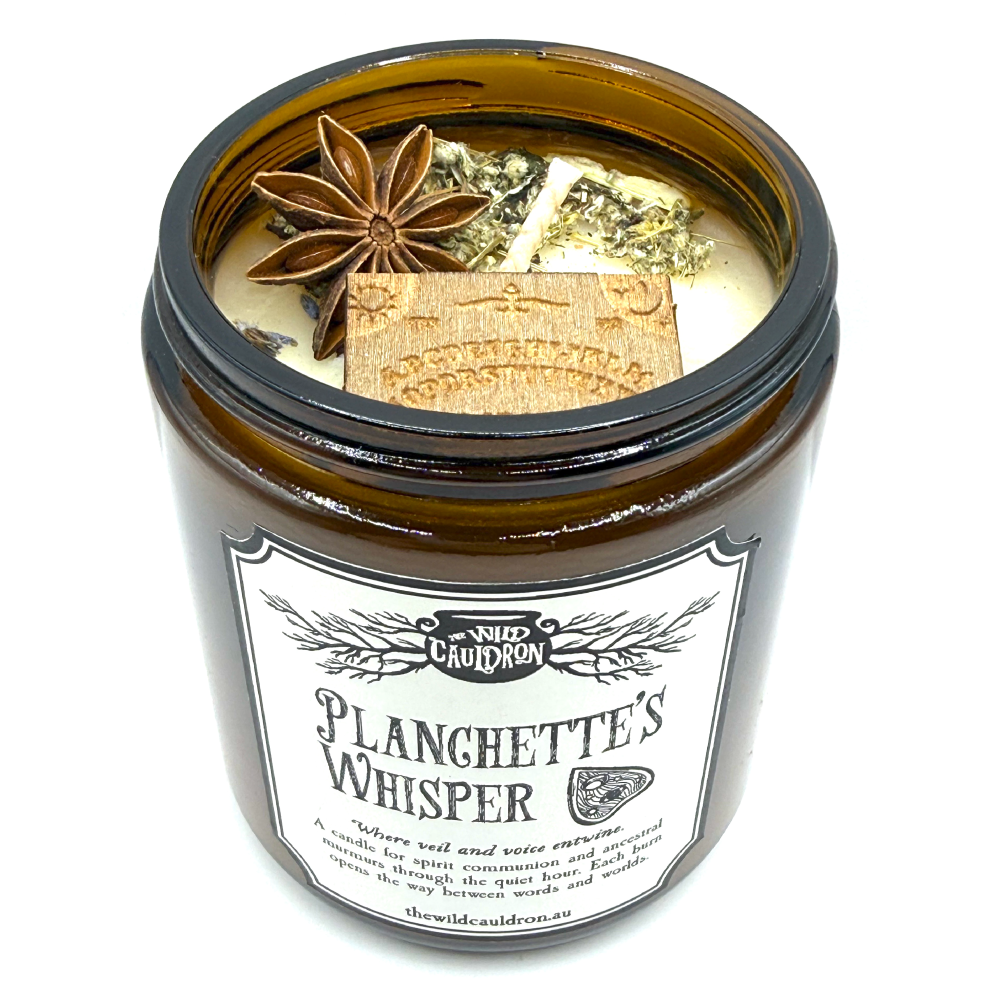 Planchette’s Whisper ritual candle with mini ouija-board charm, amethyst, mugwort, star anise and lavender for spirit and ancestor work by The Wild Cauldron.